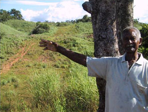 This peasant farmer’s land has a 200 meter wide cleared corridor where the two oil pipelines pass through. The pipelines have disrupted water supplies so badly that he can no longer work the farm. He has lost his fish ponds and a small mine as well as his animals and his crops. His family has moved away. This peasant farmer’s land has a 200 meter wide cleared corridor where the two oil pipelines pass through. The pipelines have disrupted water supplies so badly that he can no longer work the farm. He has lost his fish ponds and a small mine as well as his animals and his crops. His family has moved away.